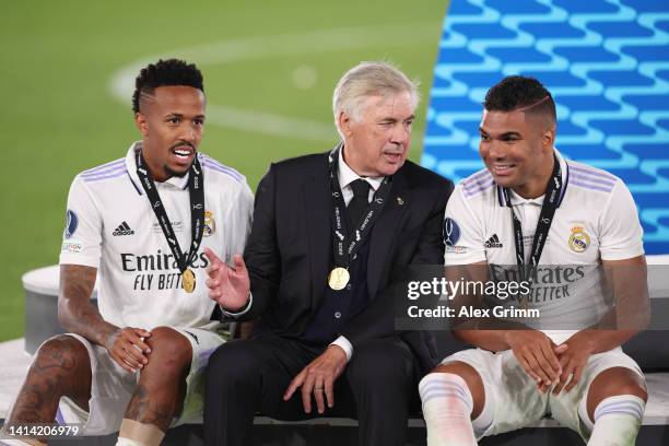 Carlo Ancelotti, Head Coach of Real Madrid, chats with Casemiro and Eder Militao after the UEFA Super Cup Final 2022 between Real Madrid CF and...