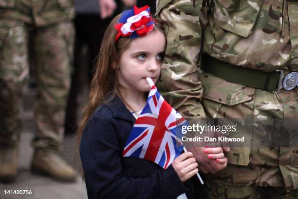 Freja Hinchliffe 5, stands with her father Major Jonathon Hinchliffe of 3rd Battalion the Yorkshire Regiment after a church service on March 16, 2012...