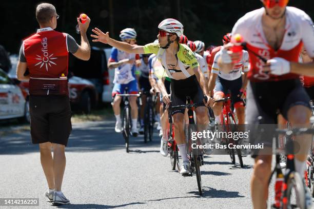 Guillaume Martin of France and Team Cofidis - Yellow Leader Jersey picks bottles from a team soigneur during the 34th Tour de l'Ain 2022 - Stage 3 a...
