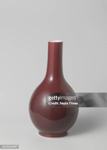 Pear-shaped bottle vase with a red glaze, Bottle-shaped vase of porcelain with a pear-shaped body and long, cylindrical neck, covered with a...