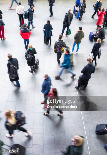 passengers in station hall - subway station stock pictures, royalty-free photos & images