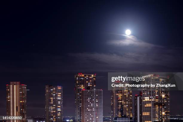 tokyo cityscape with residential buildings and moon at night. - moonlight - fotografias e filmes do acervo