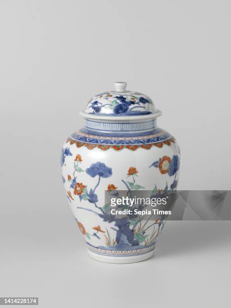 Ovoid covered jar with flowering plants, Ovoid covered jar of porcelain, painted in underglaze blue and on the glaze red, green, yellow and black. On...