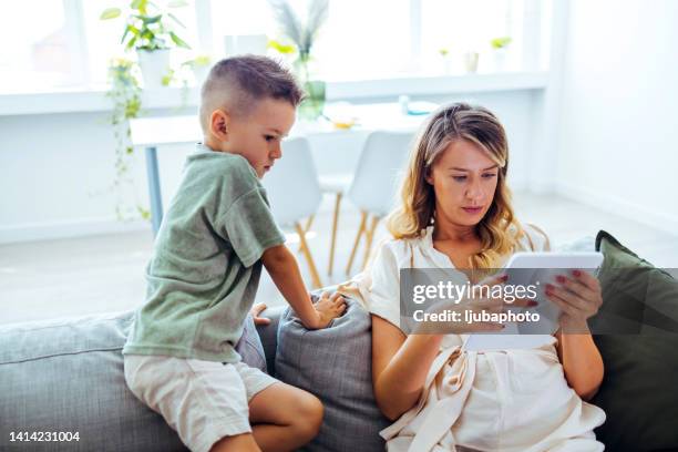 family using technology in their everyday live. - family law stockfoto's en -beelden