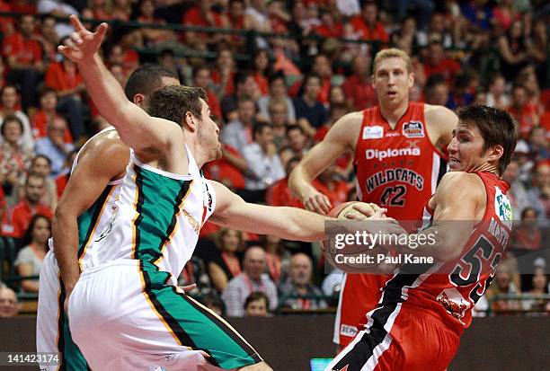 Mitch Norton of the Crocodiles and Damian Martin of the Wildcats contest for the ball during the round 24 NBL match between the Perth Wildcats and...