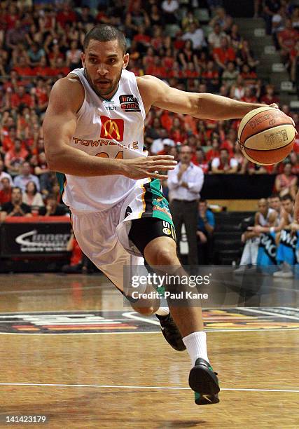 Michael Cedar of the Crocodiles drives into the key during the round 24 NBL match between the Perth Wildcats and the Townsville Crocodiles at...