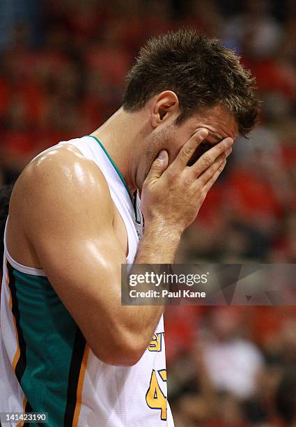 Ben Allen of the Crocodiles leaves the court after receiving an injury to his eye during the round 24 NBL match between the Perth Wildcats and the...