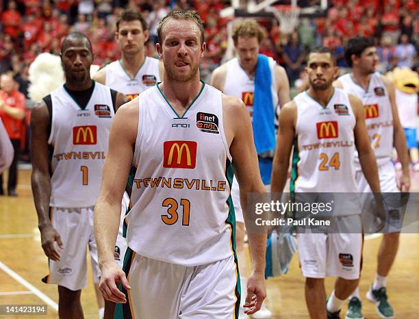 Jacob Holmes of the Crocodiles leads the team from the court after being defeated during the round 24 NBL match between the Perth Wildcats and the...