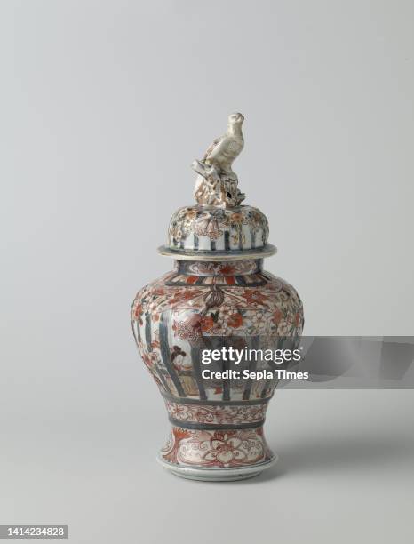 Covered baluster jar with figures in an interior behind framework, prunus trees and floral scrolls, Baluster shaped lidded jar of porcelain with a...