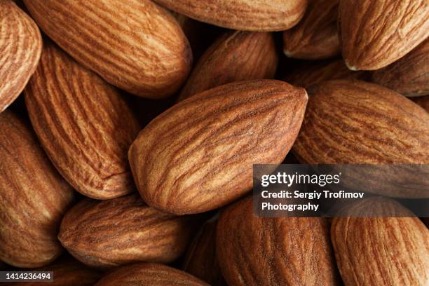 almond nuts macro photo, food background - almond stock pictures, royalty-free photos & images