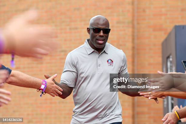 Hall of Fame running back Terrell Davis celebrates with fans as he is introduced prior to the Pro Football Hall of Fame Enshrinement on August 06,...