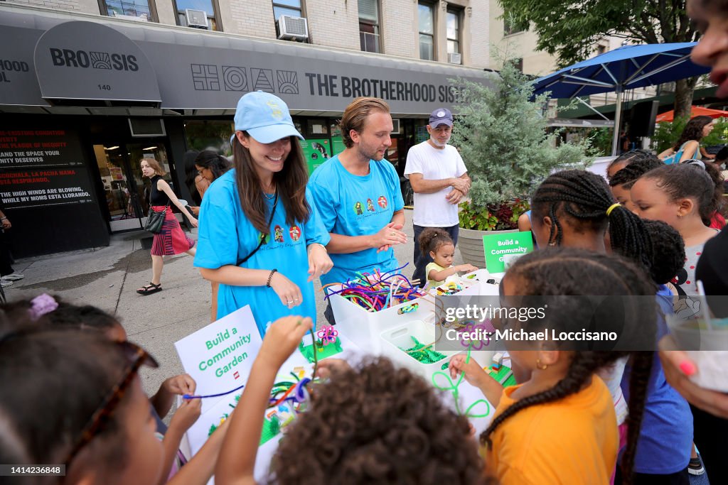 Children and families participate in activities as The LEGO Group