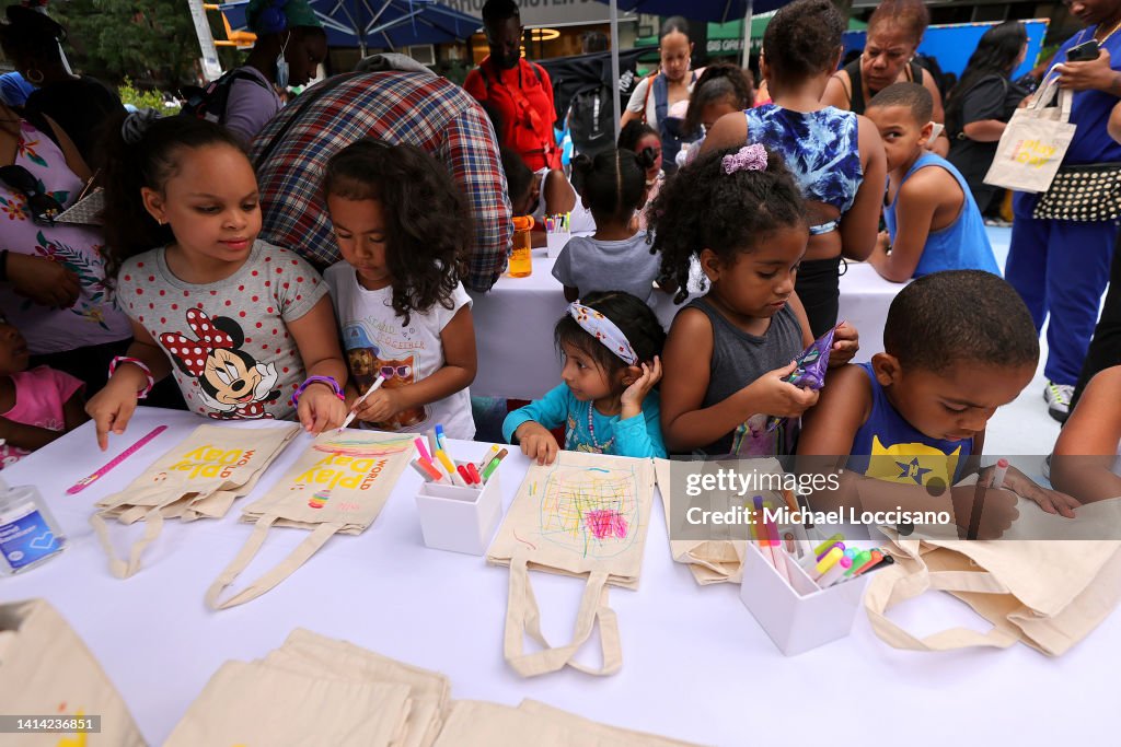 Children and families participate in activities as The LEGO Group