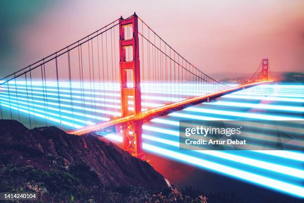 blue light trails flowing under the golden gate bridge at night with global connections. - golden gate bridge night 個照片及圖片檔