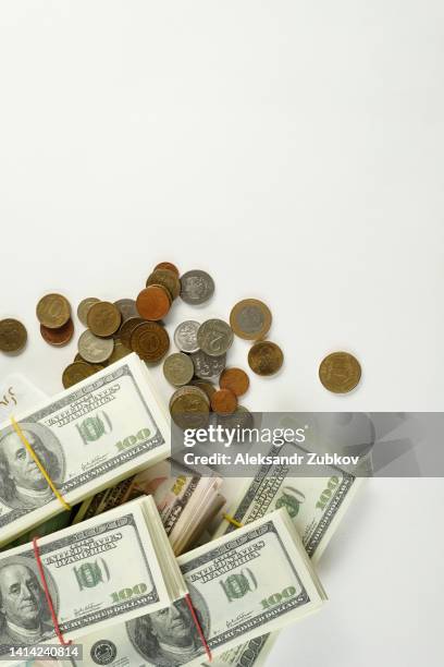 us dollars and euros, eu and us banknotes in bundles on a white background. coins from different countries. salary, bribe, profit or credit funds. the concept of business and finance, economics, insurance, investment and accumulation of funds. - american one hundred dollar bill stockfoto's en -beelden
