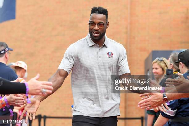 Hall of Fame wide receiver Calvin Johnson celebrates with fans as he is introduced prior to the Pro Football Hall of Fame Enshrinement on August 06,...