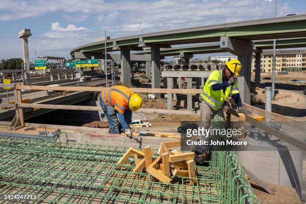 Workers construct an overpass as part of the Irving Interchange infrastructure project near the site of the former Dallas Cowboys Stadium on August...
