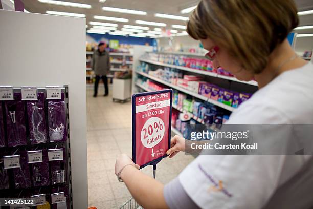 Deputy branch manager Wenke Kienitz prepares a sign for special offers at a Schlecker drugstore on March 16, 2012 in Strausberg, Germany. The German...