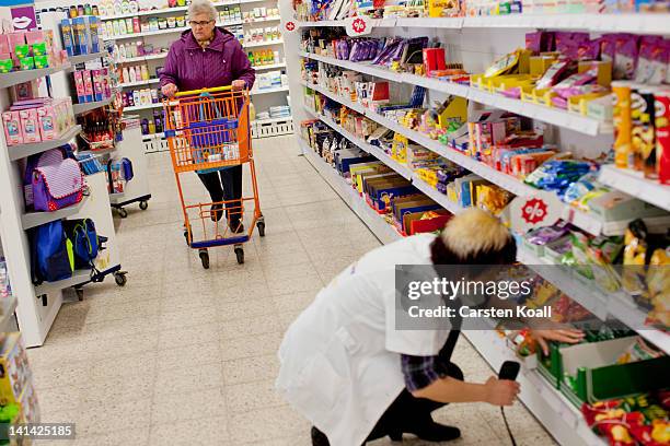 Customer walks past shelves at a Schlecker drugstore on March 16, 2012 in Strausberg, Germany. The German drugstore chain released a list of 2,010...