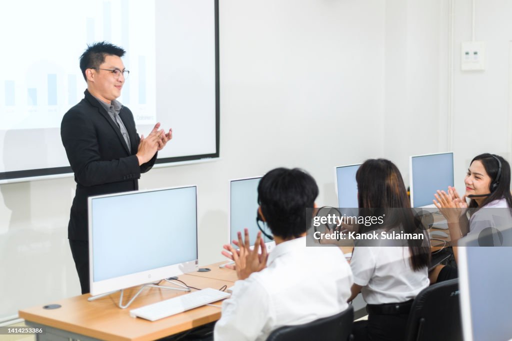 Professor talking to students in college classroom
