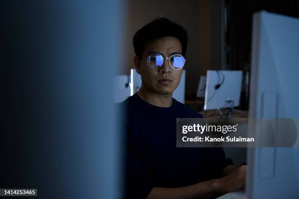 computer hacker stealing information with computer - asian violence stock pictures, royalty-free photos & images