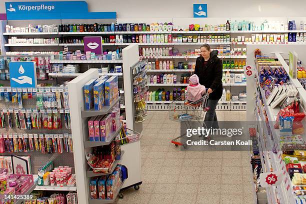 Customer walks past shelves at a Schlecker drugstore on March 16, 2012 in Strausberg, Germany. The German drugstore chain released a list of 2,010...