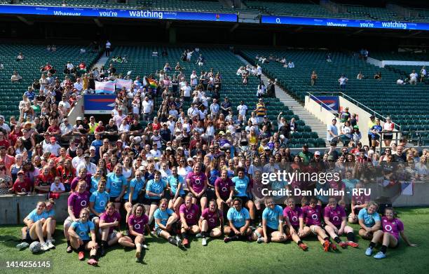 The England players pose for a group picture with some of the fans who watching the training session at Twickenham Stadium on August 11, 2022 in...