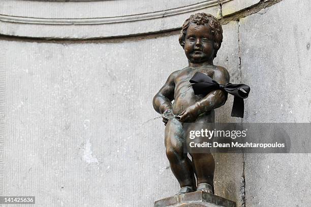 The Manneken Pis statue wears a black arm band in the city centre during a national day of mourning on March 16, 2012 in Heverlee, Belgium. Belgium...