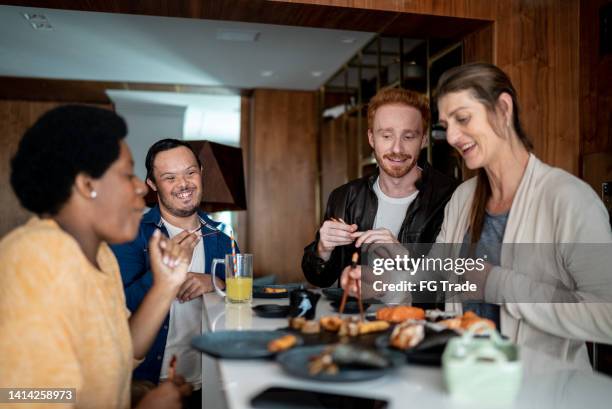 friends talking and eating at home - japanese food stock pictures, royalty-free photos & images