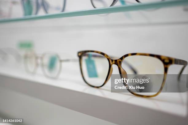 myopic glasses in an optician's store - lente strumento ottico foto e immagini stock