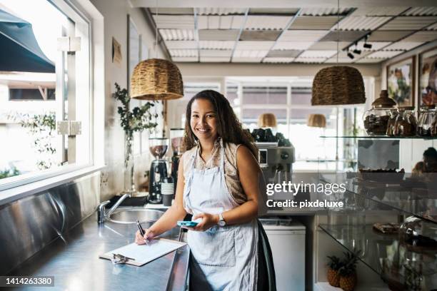 entrepreneur or small business owner doing inventory, analyzing profit or supply management at startup cafe or shop. successful face portrait of retail worker working on stock order on ecommerce app - micro finance stock pictures, royalty-free photos & images