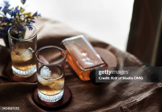 the glass of iced whisky on the table - cognac brandy stock pictures, royalty-free photos & images