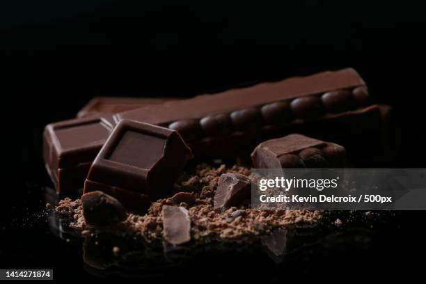 close-up of chocolates on black background - security screen stockfoto's en -beelden