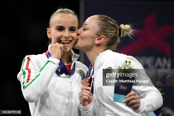 First placed Asia D'Amato of Italy and third placed Martina Maggio pose with their respective medals after competing in the Women's Artistic...