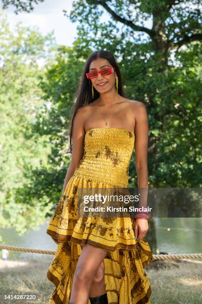 Avni Kapoor wears Balenciaga sunglasses, H&M earrings and a dress from a boutique in Italy at the Wilderness Festival at Cornbury Park on August 05,...