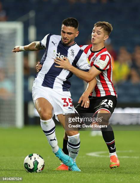 OkayYokuslu of West Bromwich Albion is challenged by James McAtee during the Carabao Cup First Round match between West Bromwich Albion and Sheffield...