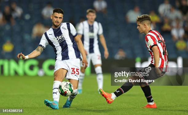 OkayYokuslu of West Bromwich Albion passes the ball pastJames McAtee during the Carabao Cup First Round match between West Bromwich Albion and...