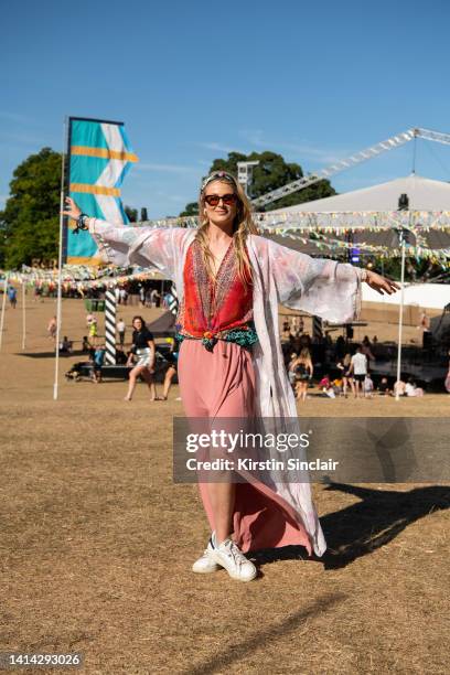 Daisy Dickinson wears a Mr Portobello kimono, Adidas trainers and a vintage top, skirt, sunglasses and scarf at the Wilderness Festival at Cornbury...