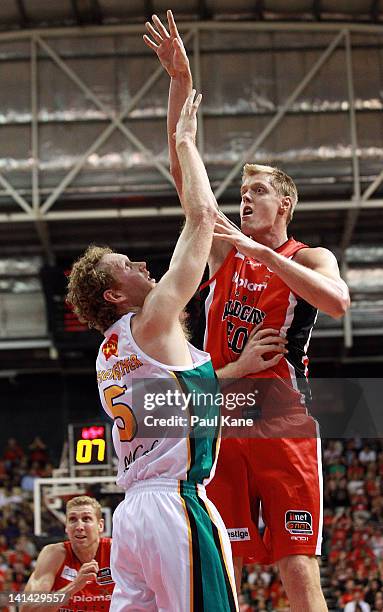 Luke Nevill of the Wildcats shoots over Luke Schenscher of the Crocodiles during the round 24 NBL match between the Perth Wildcats and the Townsville...