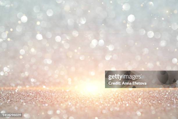 silver background made of sequins and light beam. holiday concept. merry christmas and a happy new year. copy space for your design. selective focus - sparkling stock-fotos und bilder