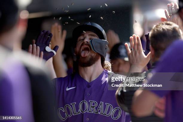 Brendan Rodgers of the Colorado Rockies celebrates in the dugout1 after hitting a three RBI home run against the St Louis Cardinals in the seventh...