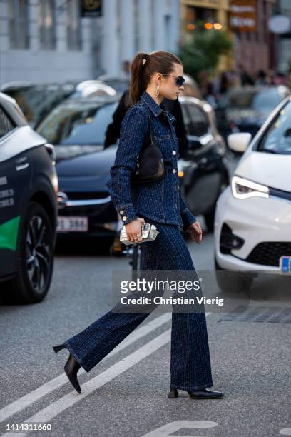 Emilie Billington seen wearing denim jacket, flared pants, black bag outside Baum & Pferdgarten during Copenhagen Fashion Week Spring/Summer 2023 on...