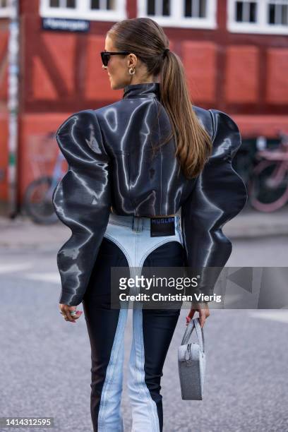 Nina Sandbech seen wearing black cropped jacket, silver Balenciaga bag, Mugler two tone denim jeans outside Baum & Pferdgarten during Copenhagen...