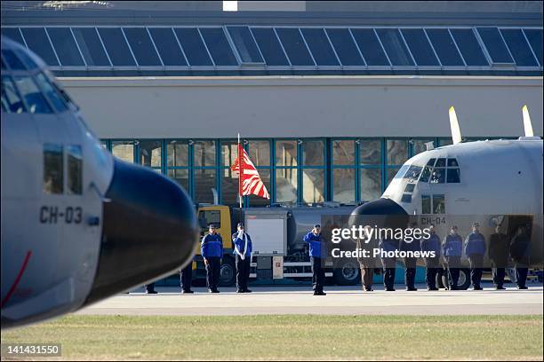 Police play tribute as the two military C130 planes leave Sion airport carrying home the bodies of those killed in the Swiss bus crash on March 16,...