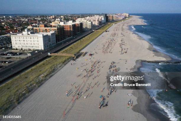 In an aerial view, volleyball players take to the beach on August 10, 2022 on Long Beach in Long Beach, New York, United States. During the summer...