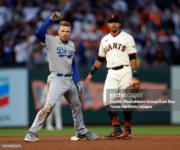 Los Angeles Dodgers' Will Smith celebrates his double as San Francisco Giants shortstop Dixon Machado looks on in the sixth inning of their MLB game...