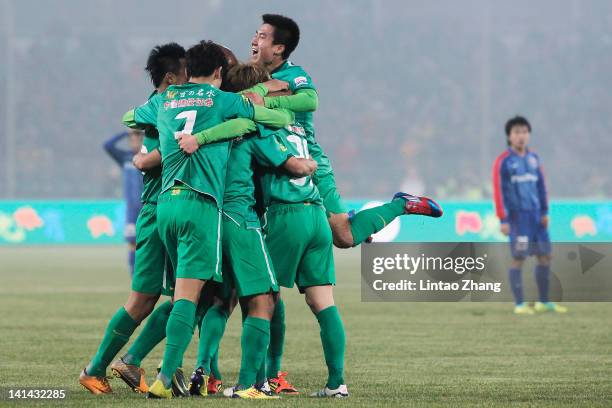 Players of Beijing Guoan celebrate a goal during the Chinese Super League match against Shanghai Shenhua at Workers Stadium on March 16, 2012 in...
