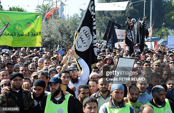 Tunisian islamists hold banners and flags and shout slogans as they take part in a demonstration on March 16, 2012 in Tunis. Several thousand men and...