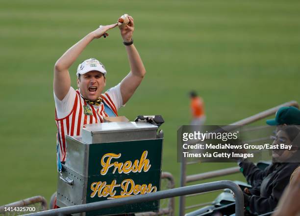 Hal Hal the Hot Dog Guy Gordon leads a chant for fans in the right field bleachers during the Oakland Athletics game against the Houston Astros at...