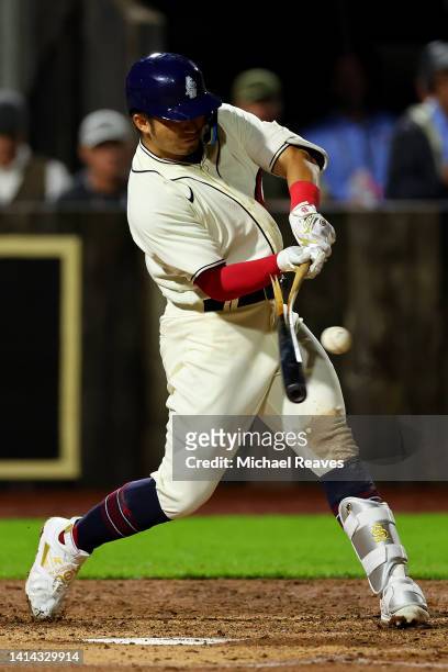 Seiya Suzuki of the Chicago Cubs breaks his bat during the seventh inning of the game against the Cincinnati Reds at Field of Dreams on August 11,...